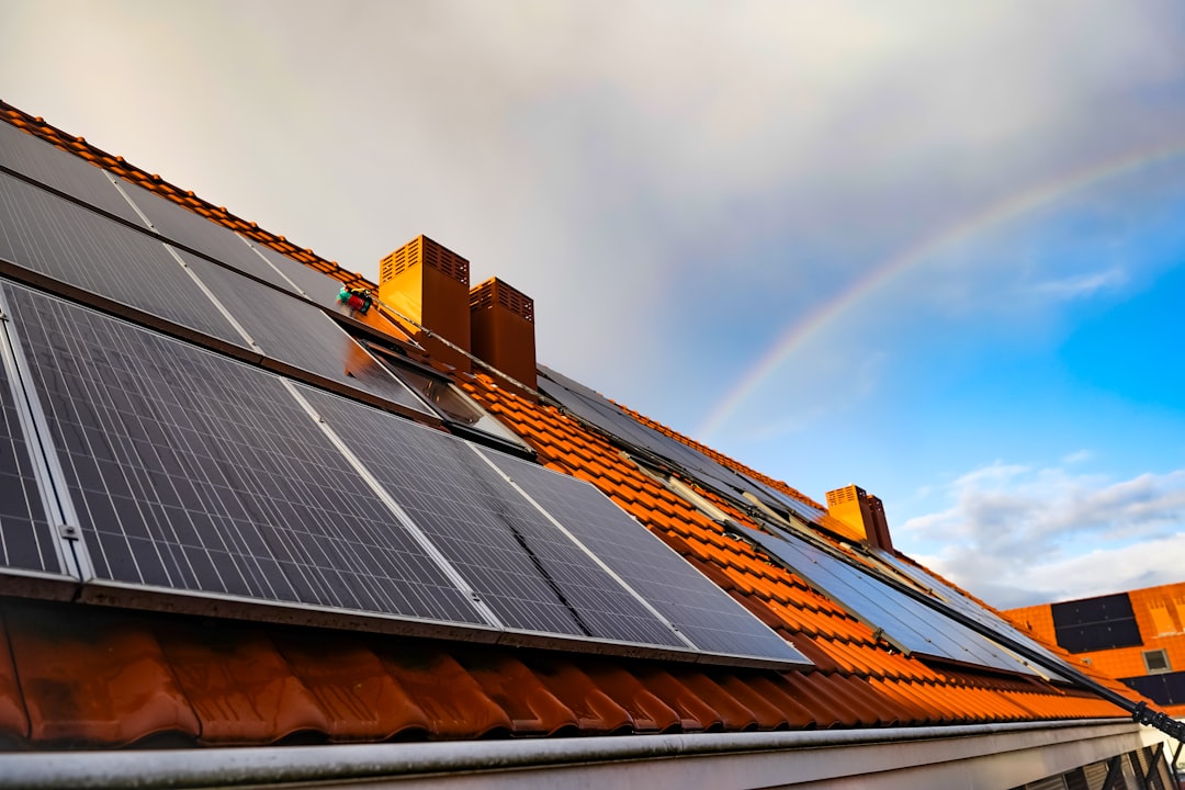 gallery-04 a-solar-panel-on-a-roof-with-a-rainbow-in-the-background-0syvpkyzc-m