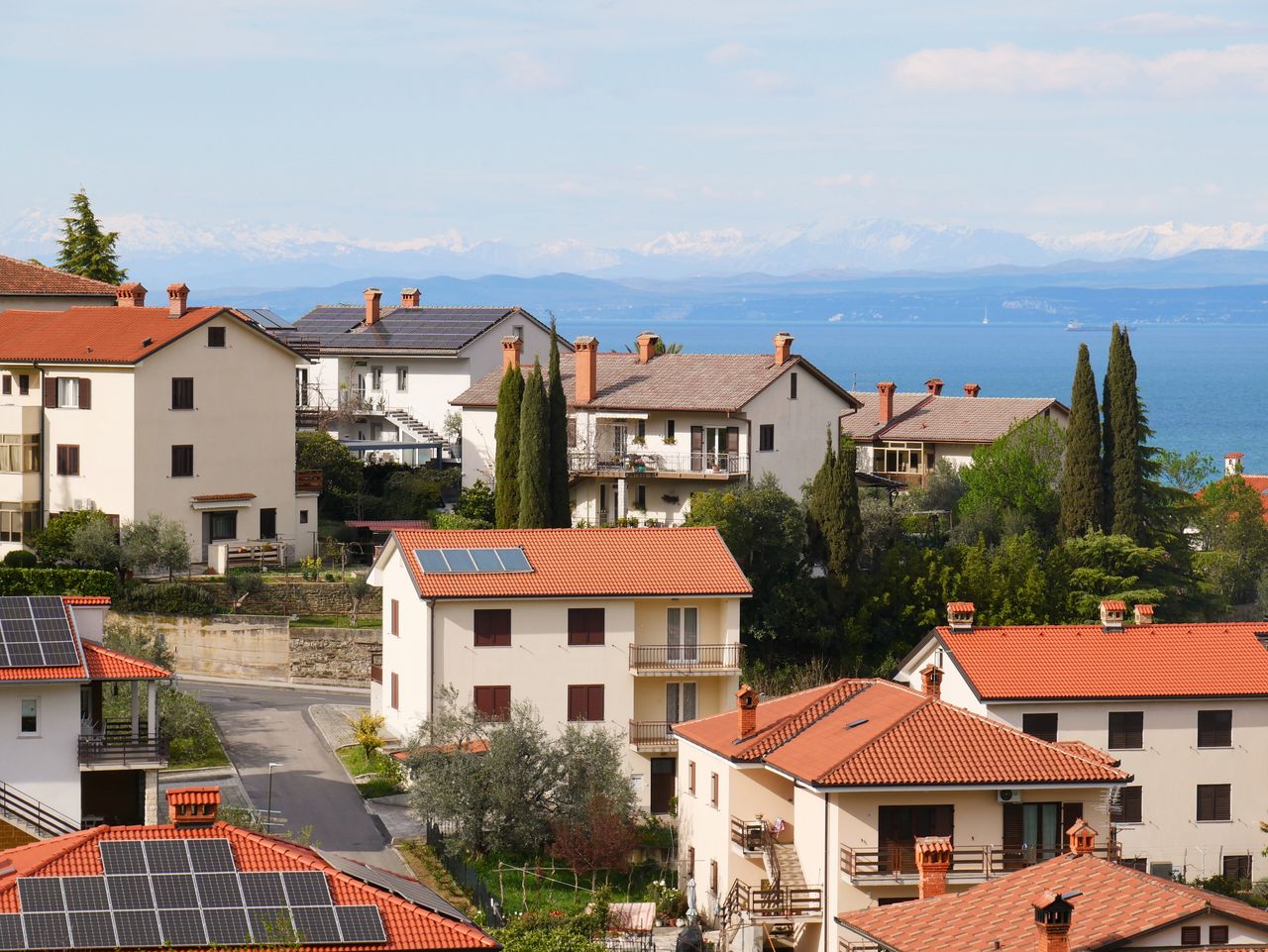 gallery-02 Picturesque Mediterranean village with red-tiled roofs and sea view, showcasing serene coastal living.
